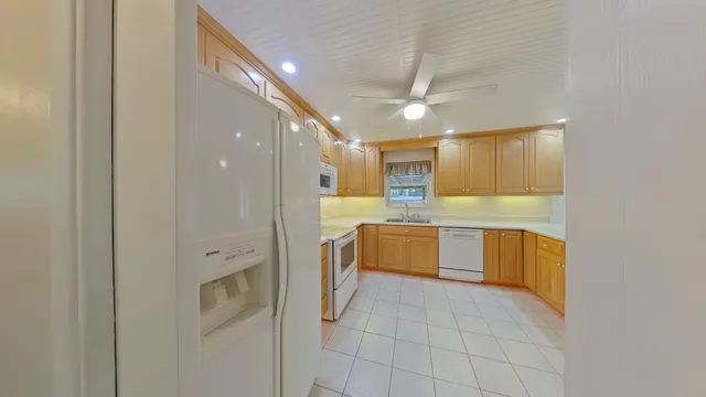 a dining room with furniture and a potted plant