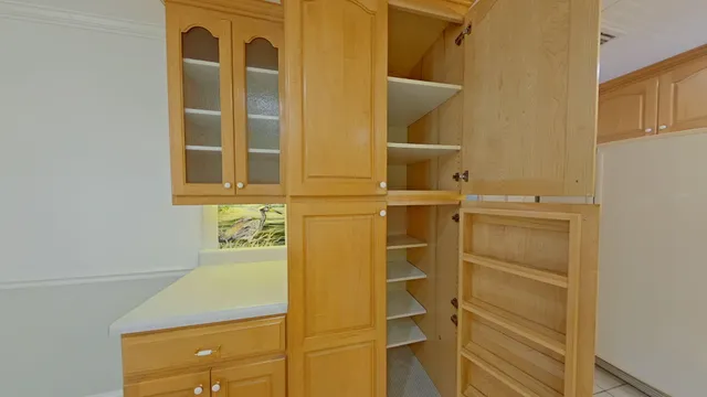 a living room with furniture a bookshelf and a window
