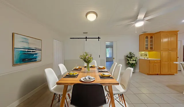 a bedroom with a large bed and a potted plant