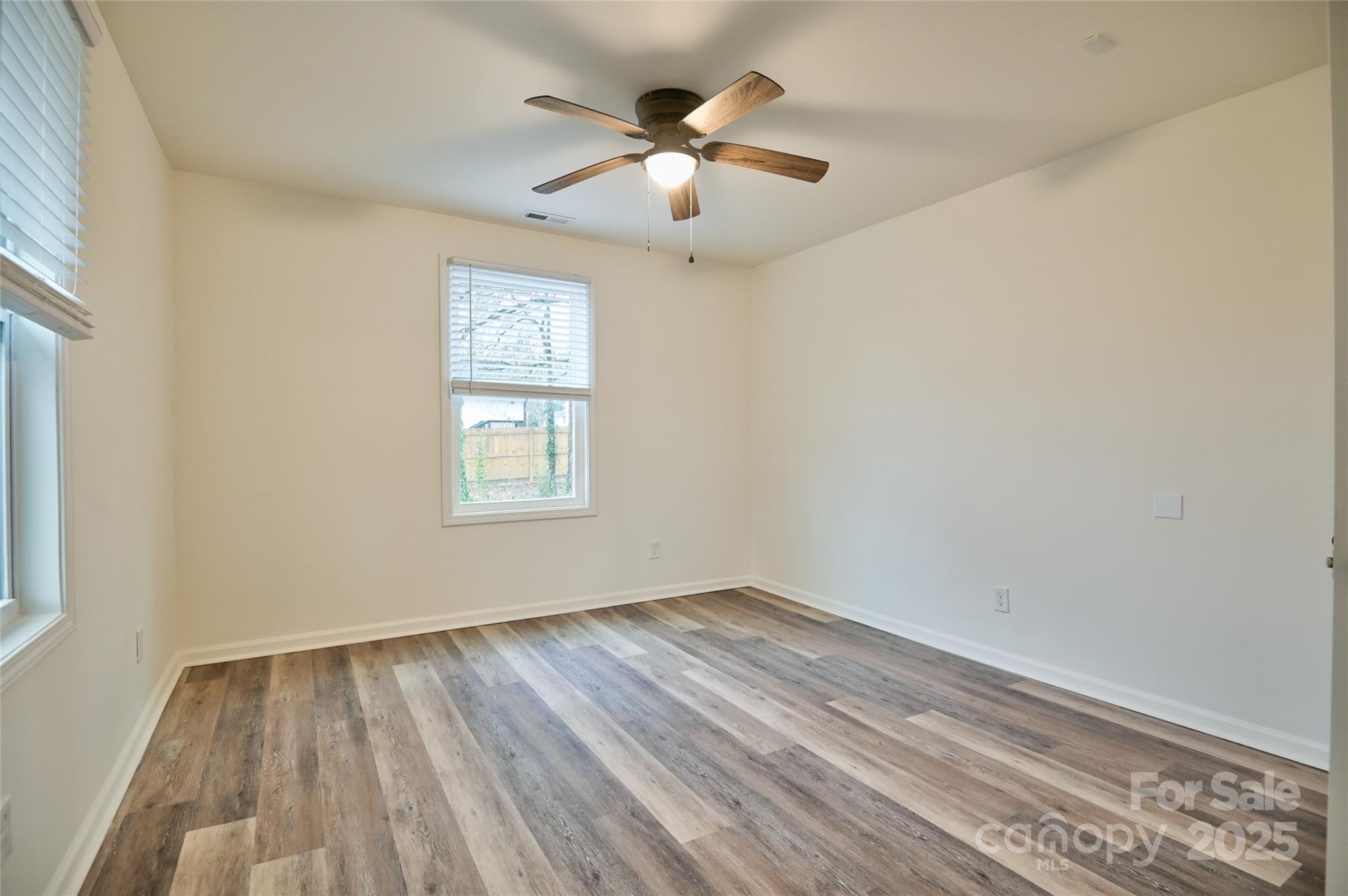 313 Heyward Street Rock Hill, SC 29730 - Photo 11 of 29 a view of an empty room with wooden floor and a window