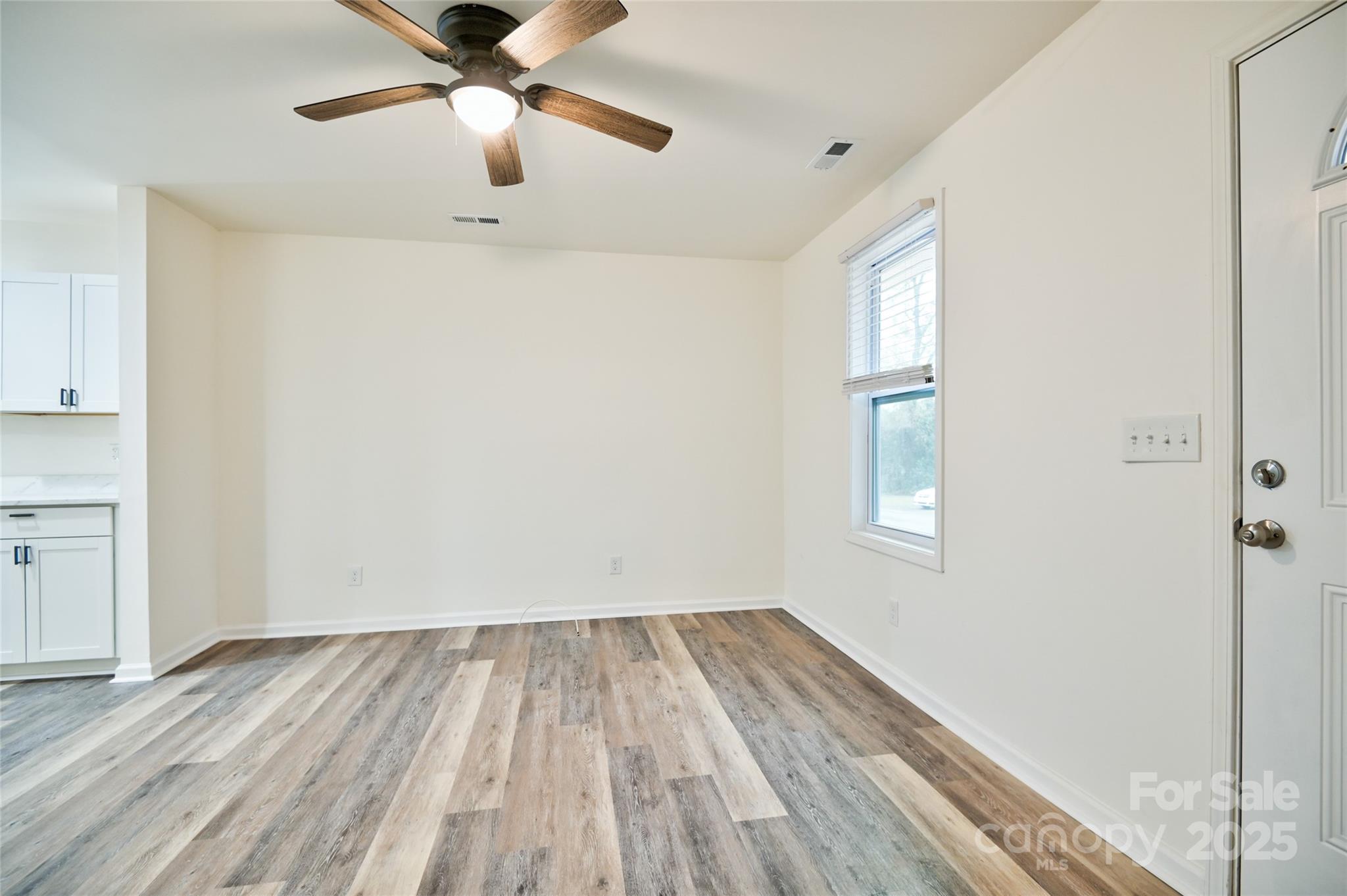 313 Heyward Street Rock Hill, SC 29730 - Photo 2 of 29 a view of empty room with wooden floor and fan