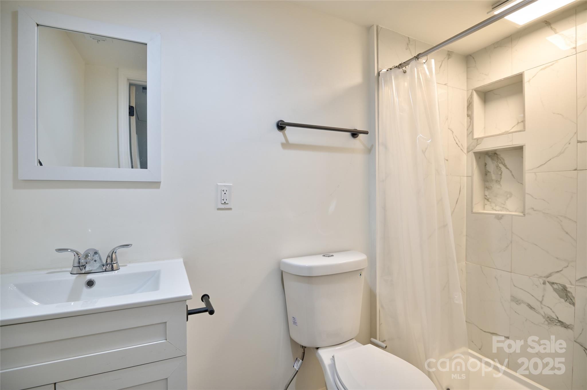 313 Heyward Street Rock Hill, SC 29730 - Photo 21 of 29 a white toilet sitting next to a bathroom sink