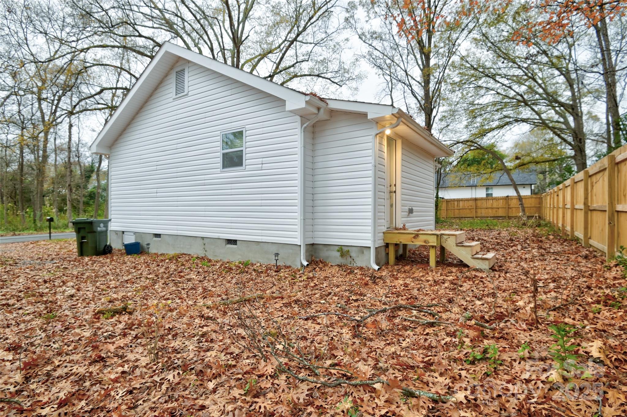 313 Heyward Street Rock Hill, SC 29730 - Photo 24 of 29 a backyard of a house with large trees and brick walls