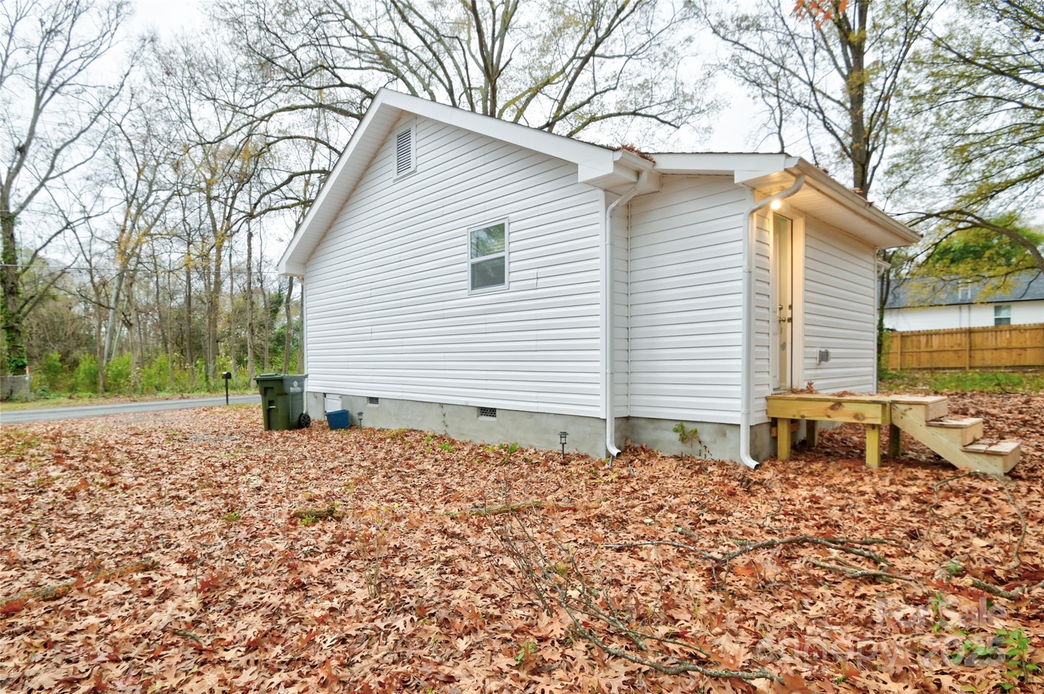 313 Heyward Street Rock Hill, SC 29730 - Photo 25 of 29 a backyard of a house with large trees and outdoor seating