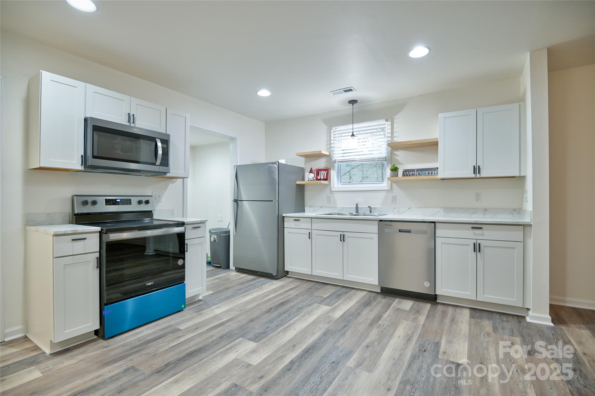313 Heyward Street Rock Hill, SC 29730 - Photo 4 of 29 a kitchen with a refrigerator stove and microwave