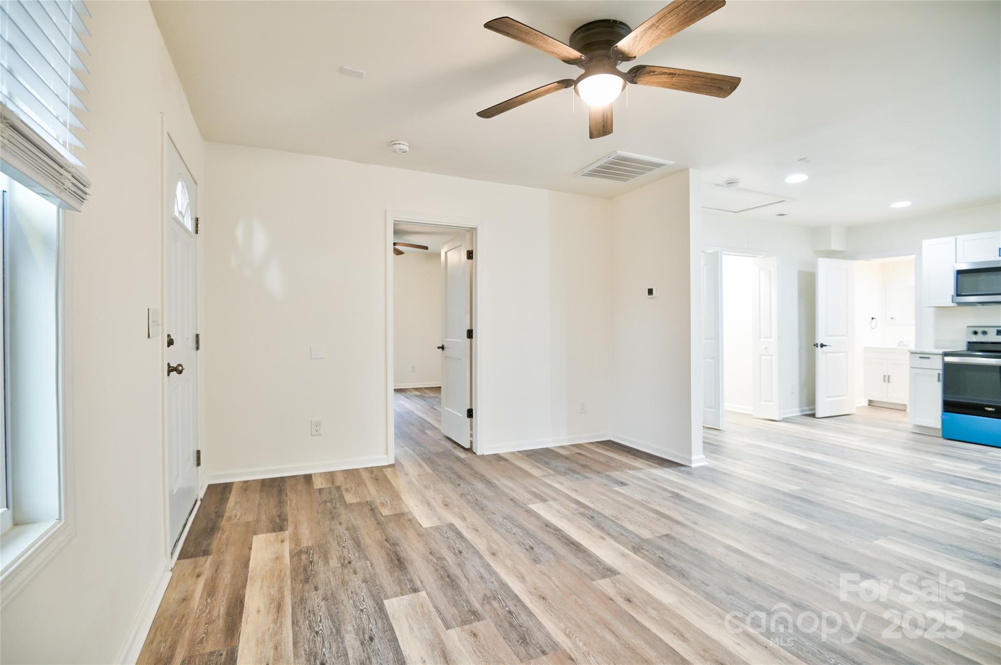 313 Heyward Street Rock Hill, SC 29730 - Photo 5 of 29 a view of empty room with wooden floor and fan