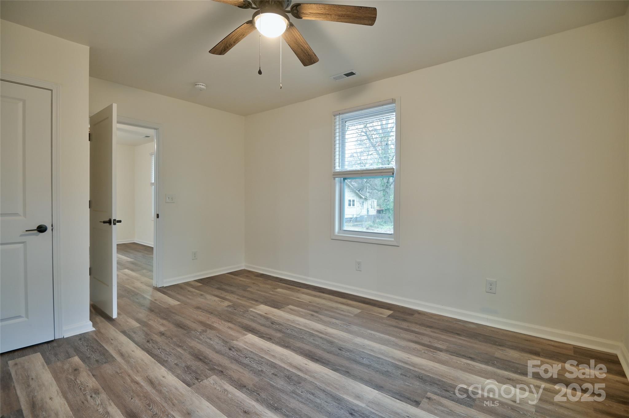 313 Heyward Street Rock Hill, SC 29730 - Photo 8 of 29 a view of an empty room with wooden floor and a window