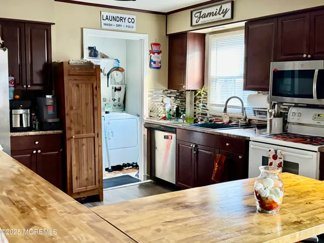 a kitchen with stainless steel appliances granite countertop a refrigerator stove and sink