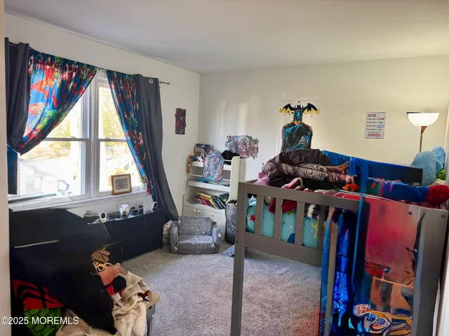 a living room with furniture a flat screen tv and a window