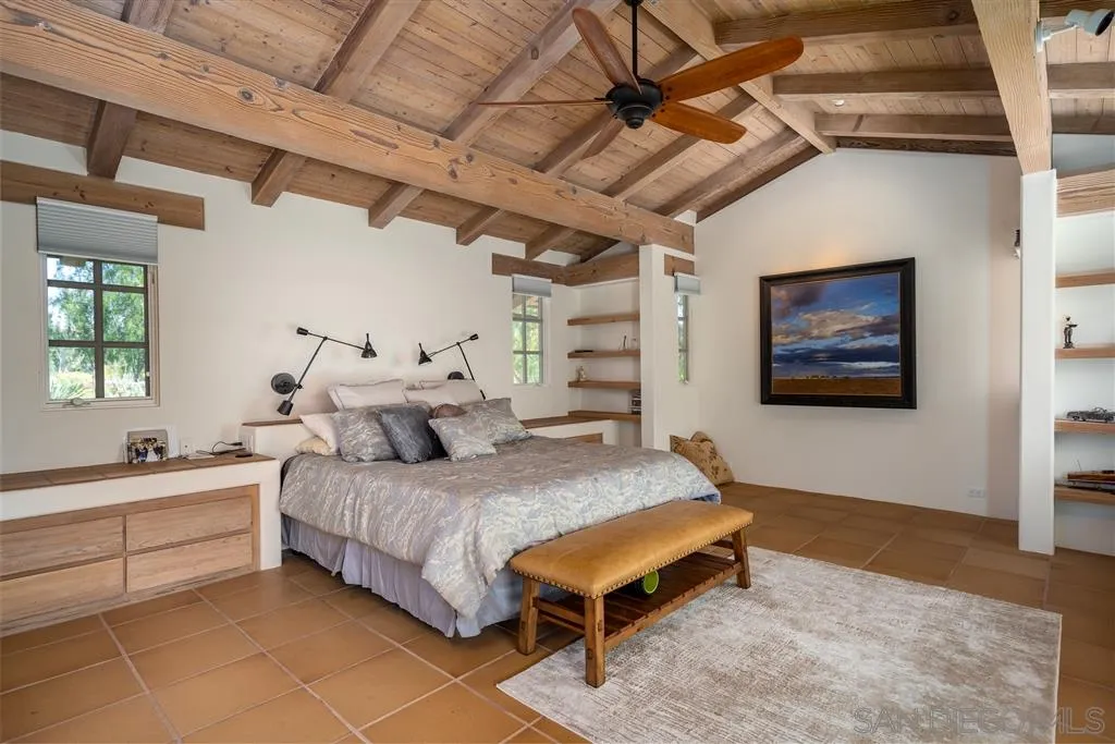 6146 Paseo Valencia Rancho Santa Fe, CA 92067 - Photo 11 of 25 a spacious bedroom with a bed and a table in it