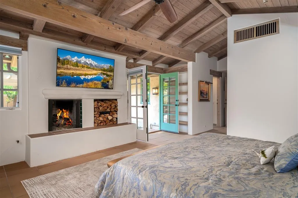 6146 Paseo Valencia Rancho Santa Fe, CA 92067 - Photo 12 of 25 a bedroom with a bed and a fireplace
