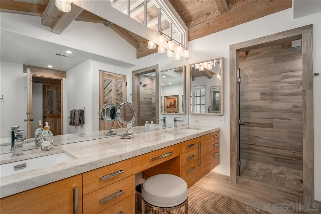 6146 Paseo Valencia Rancho Santa Fe, CA 92067 - Photo 13 of 25 a spacious bathroom with a granite countertop sink a toilet a mirror and shower