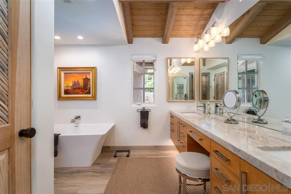 6146 Paseo Valencia Rancho Santa Fe, CA 92067 - Photo 14 of 25 a large bathroom with a double vanity sink a mirror and a bathtub