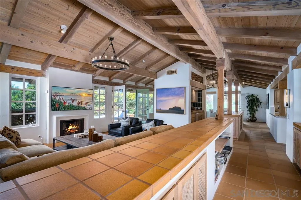 6146 Paseo Valencia Rancho Santa Fe, CA 92067 - Photo 4 of 25 a living room with furniture a fireplace and a table