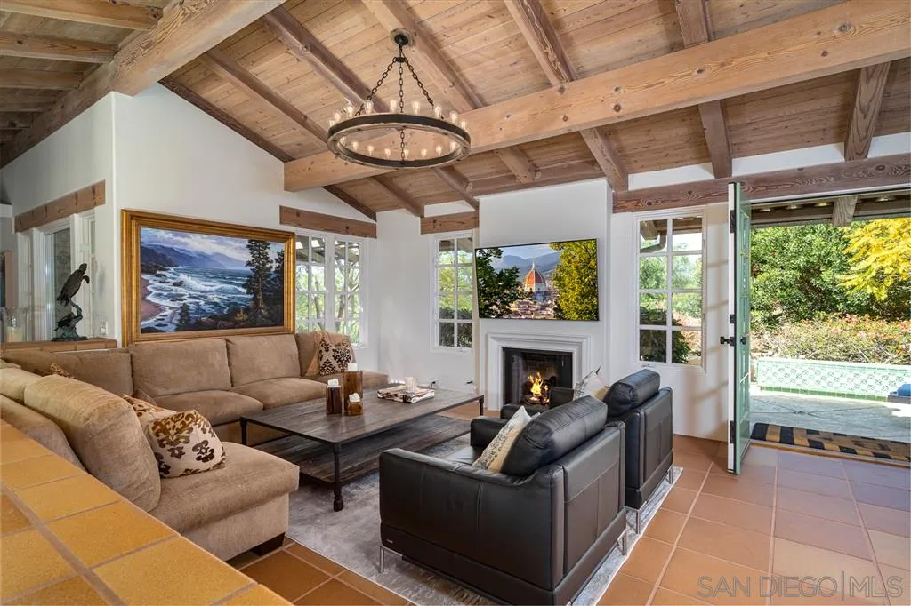 6146 Paseo Valencia Rancho Santa Fe, CA 92067 - Photo 5 of 25 a living room with furniture a fireplace and a chandelier