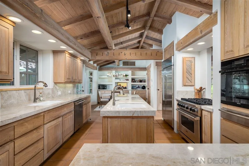 6146 Paseo Valencia Rancho Santa Fe, CA 92067 - Photo 8 of 25 a large kitchen with stainless steel appliances granite countertop a stove oven a sink dishwasher and cabinets with wooden floor