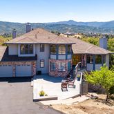 a front view of a house with a mountain
