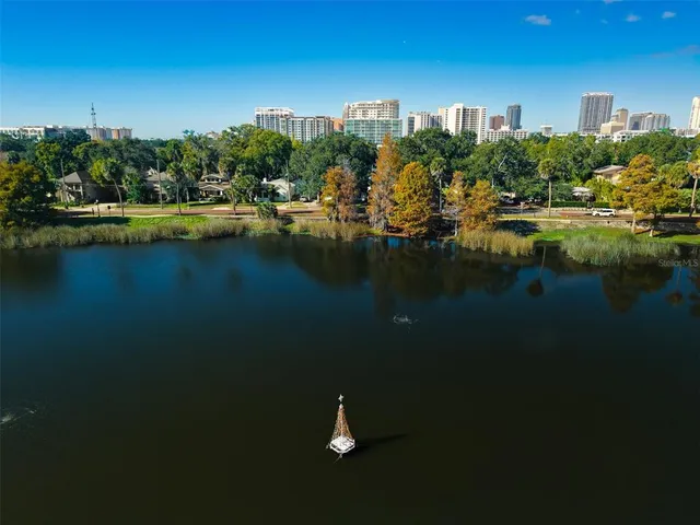 an aerial view of residential houses with outdoor space and lake view