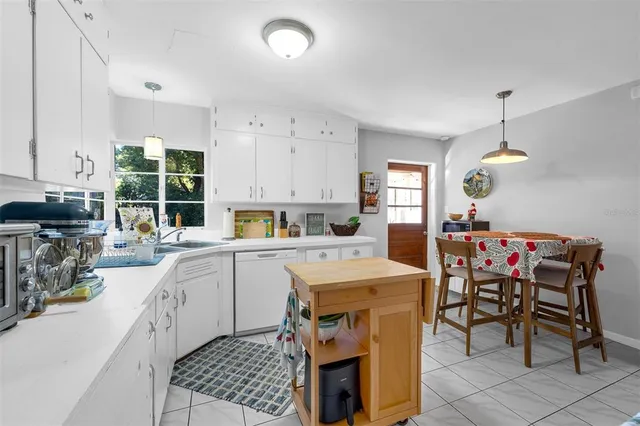 a kitchen that has a lot of cabinets in it and appliances