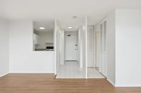 a view of a hallway with wooden floor