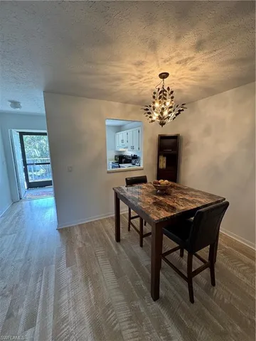 a view of a room that has a table and a chandelier