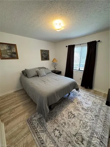 a bedroom with a bed and a flat screen television