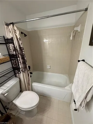 a bathroom with a toilet and a bathtub