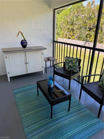 a view of a room with wooden floor and pool table