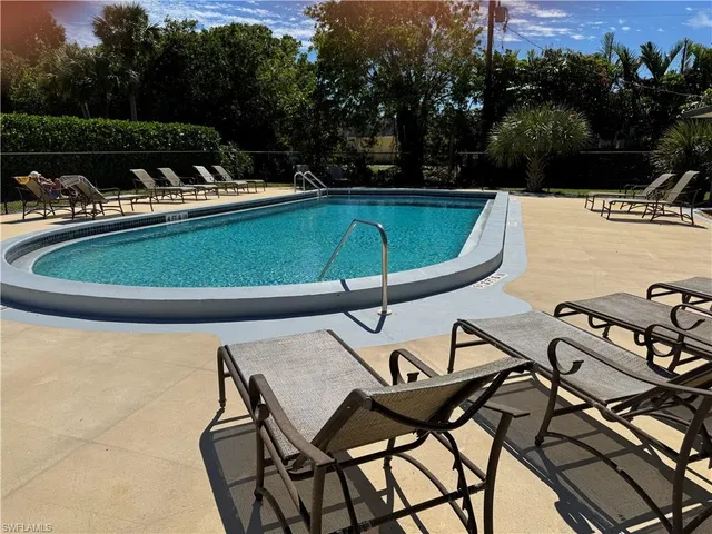 a view of a swimming pool with lounge chair