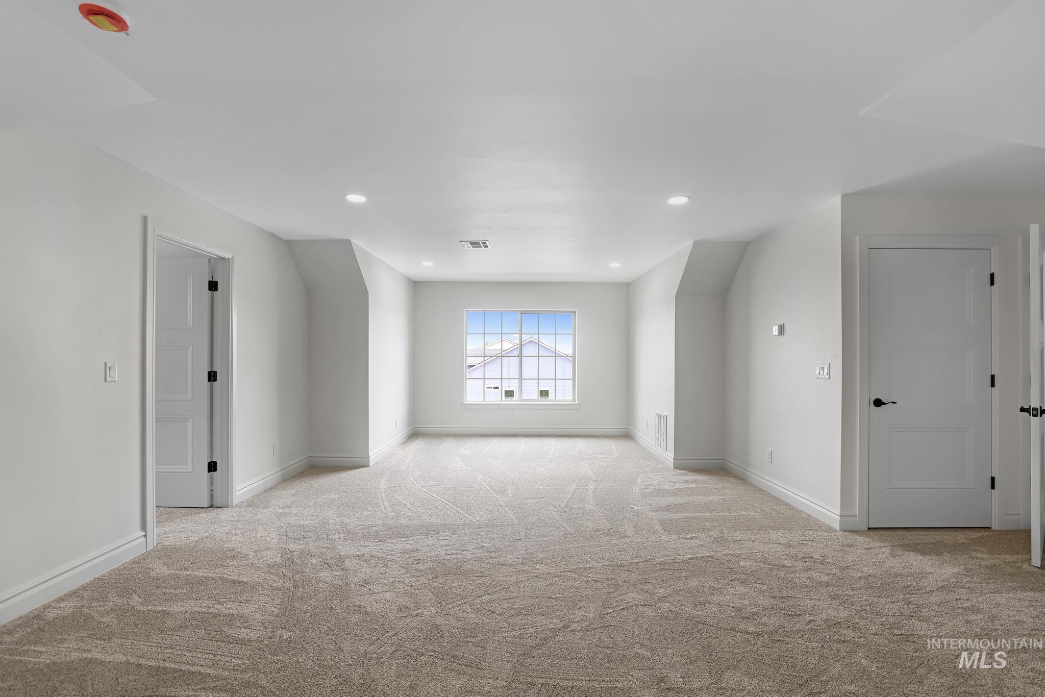 866 Quartz Road Kimberly, ID 83341 - Photo 28 of 48 Spacious room featuring neutral carpeting, white trim, recessed lighting, and a multi-pane window