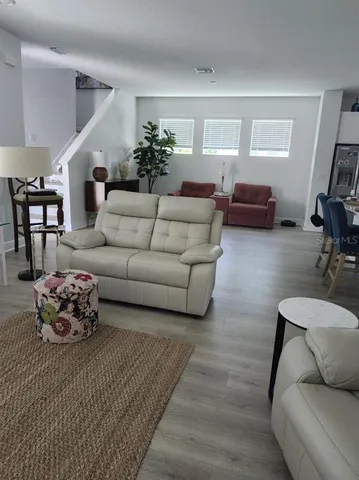 a living room with furniture and a potted plant