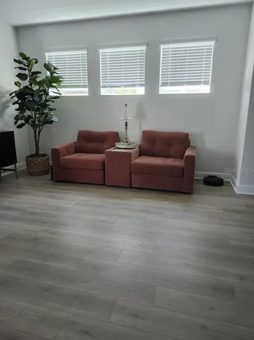 a living room with furniture and flowers