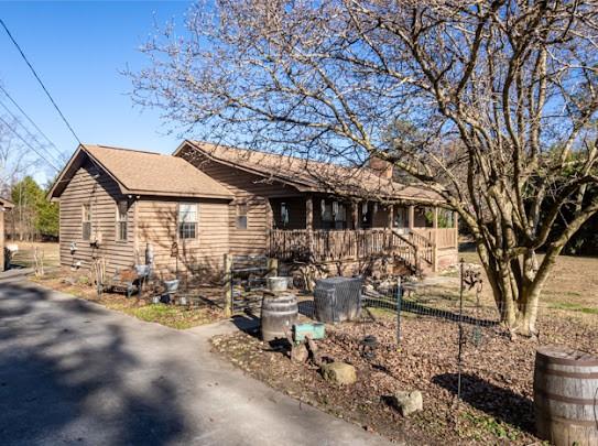 165 Lake Creek Road Cedartown, GA 30125 - Photo 2 of 28 a front view of a house with yard outdoor seating and covered with trees