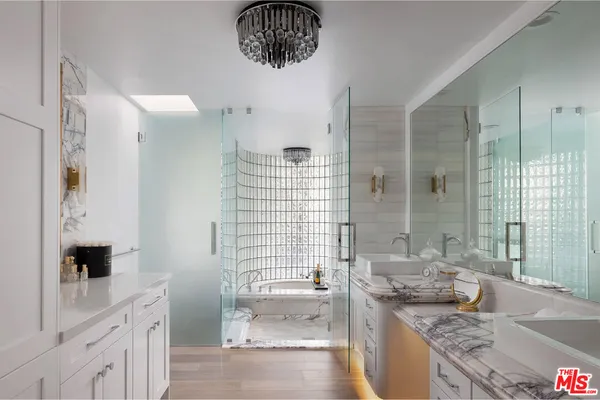 a large bathroom with a granite countertop tub sink a mirror and shower