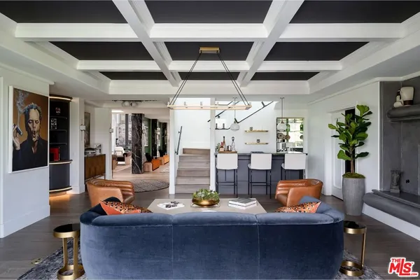 a living room with fireplace furniture and a chandelier