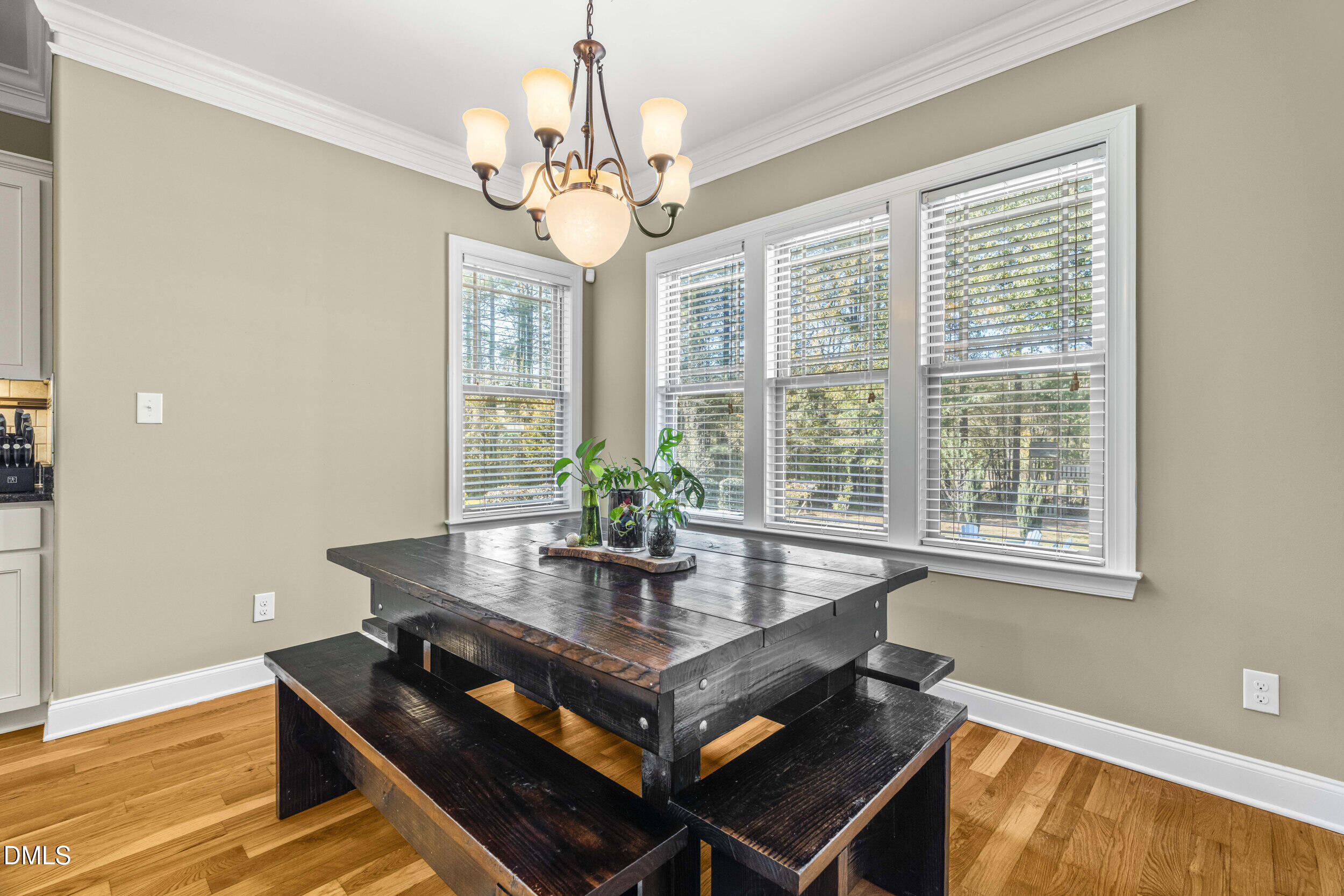 648 Fieldtrial Circle Garner, NC 27529 - Photo 15 of 56 a view of a dining room with furniture wooden floor and chandelier