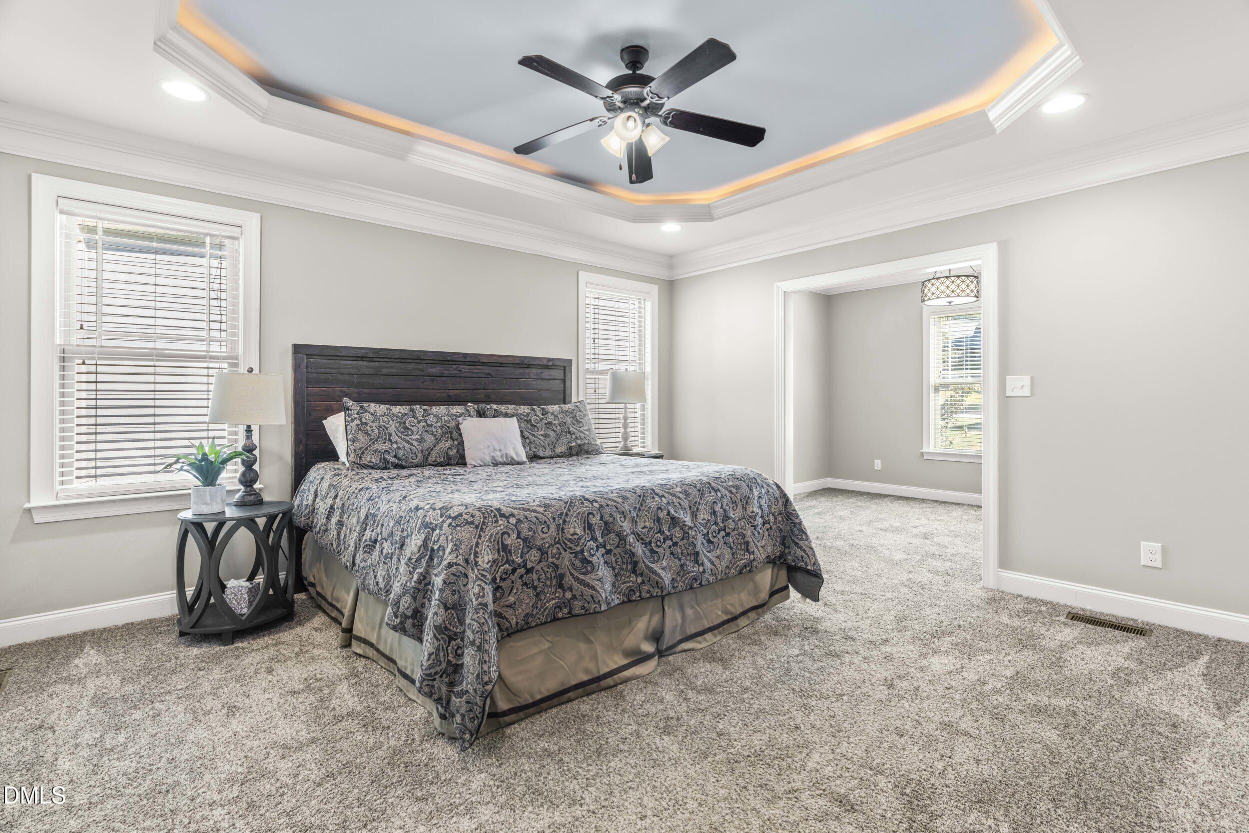 648 Fieldtrial Circle Garner, NC 27529 - Photo 21 of 56 a bedroom with a bed and a ceiling fan