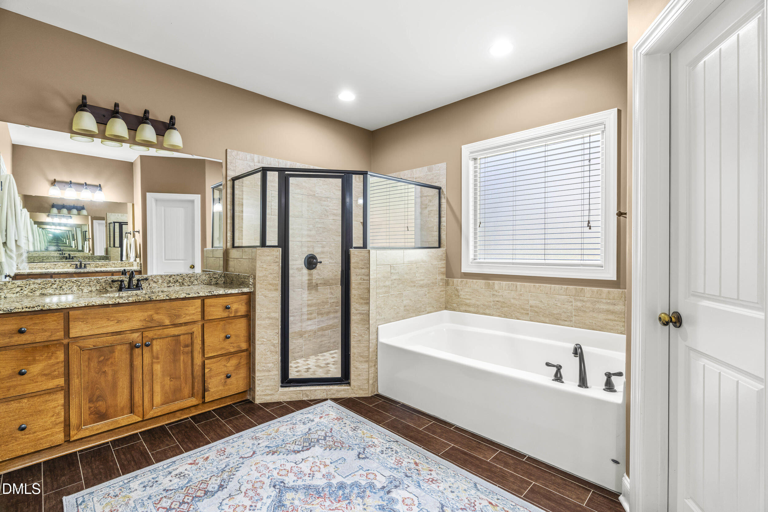 648 Fieldtrial Circle Garner, NC 27529 - Photo 26 of 56 a spacious bathroom with a tub sink and mirror