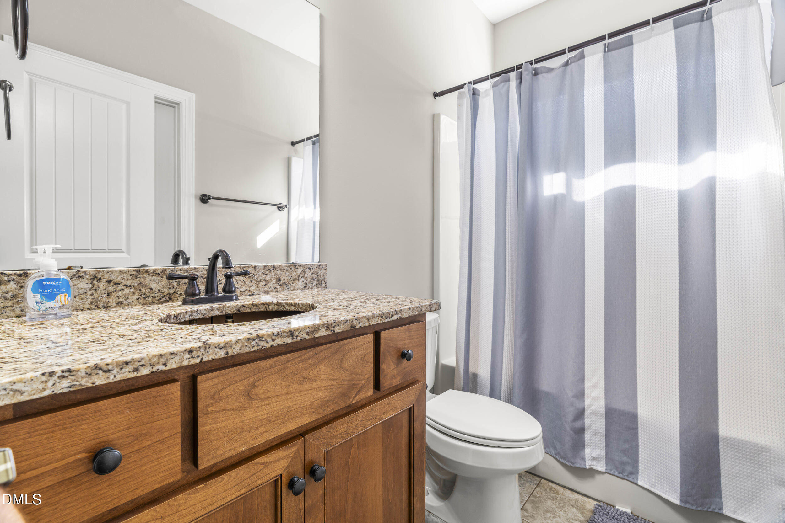 648 Fieldtrial Circle Garner, NC 27529 - Photo 27 of 56 a bathroom with a granite countertop sink toilet and mirror