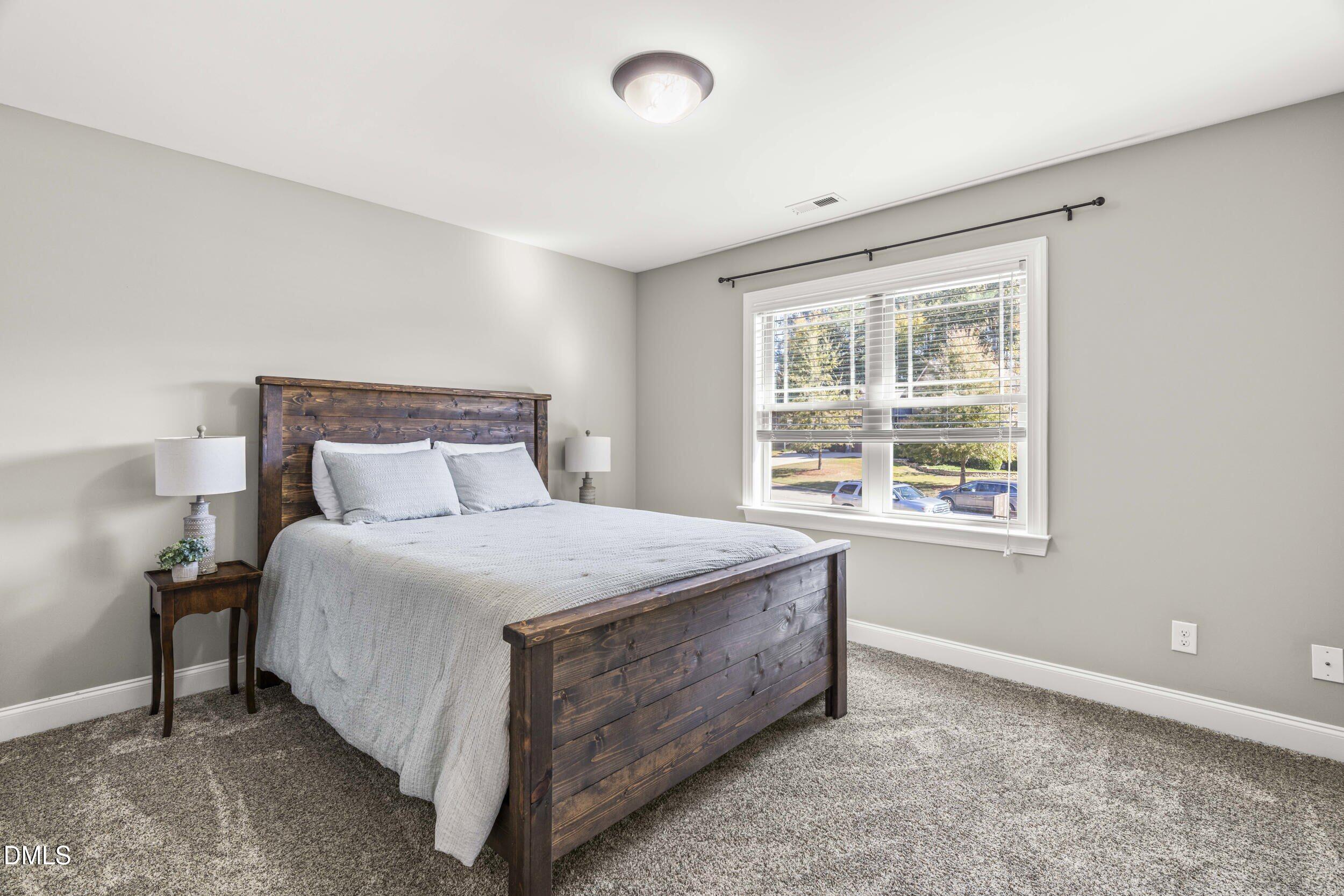 648 Fieldtrial Circle Garner, NC 27529 - Photo 30 of 56 a bedroom with a bed and a window
