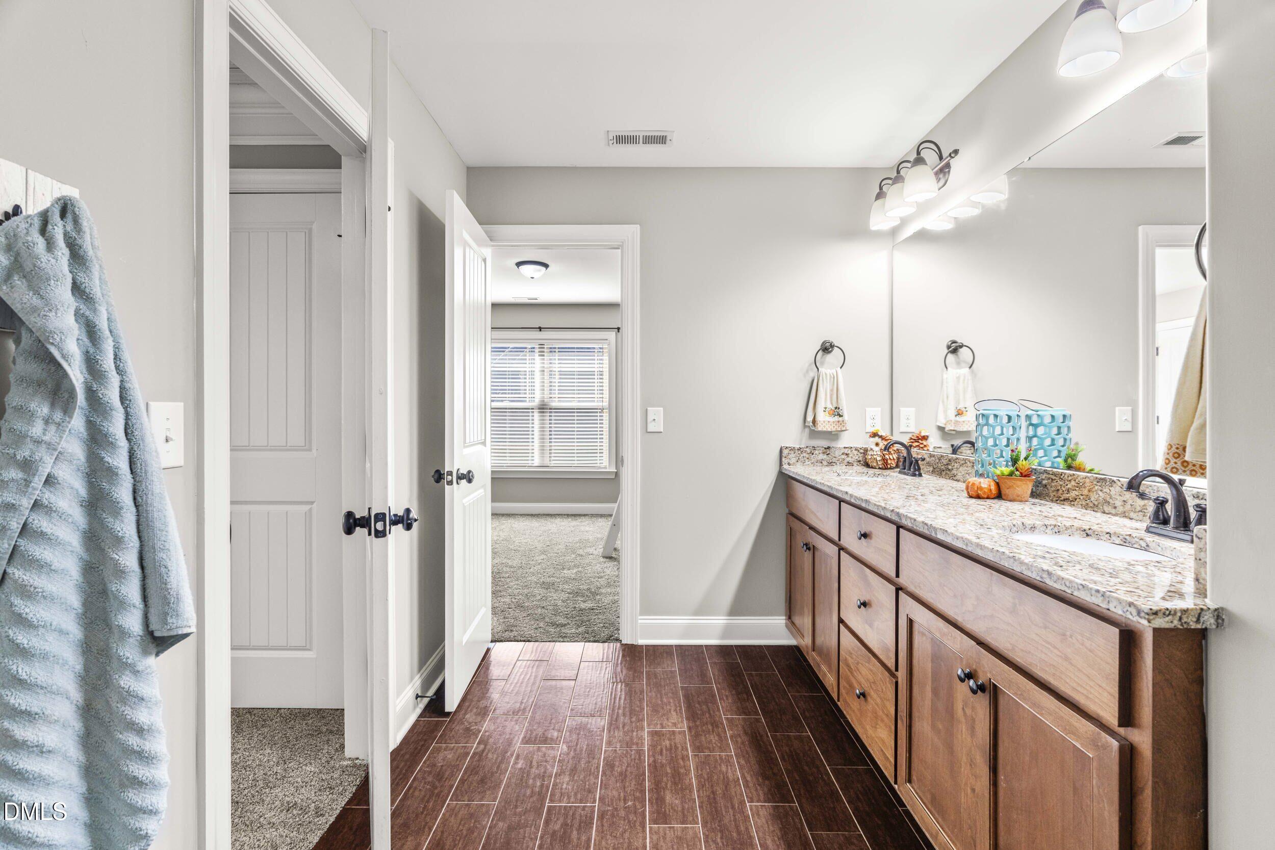 648 Fieldtrial Circle Garner, NC 27529 - Photo 34 of 56 a bathroom with a sink a vanity and a mirror