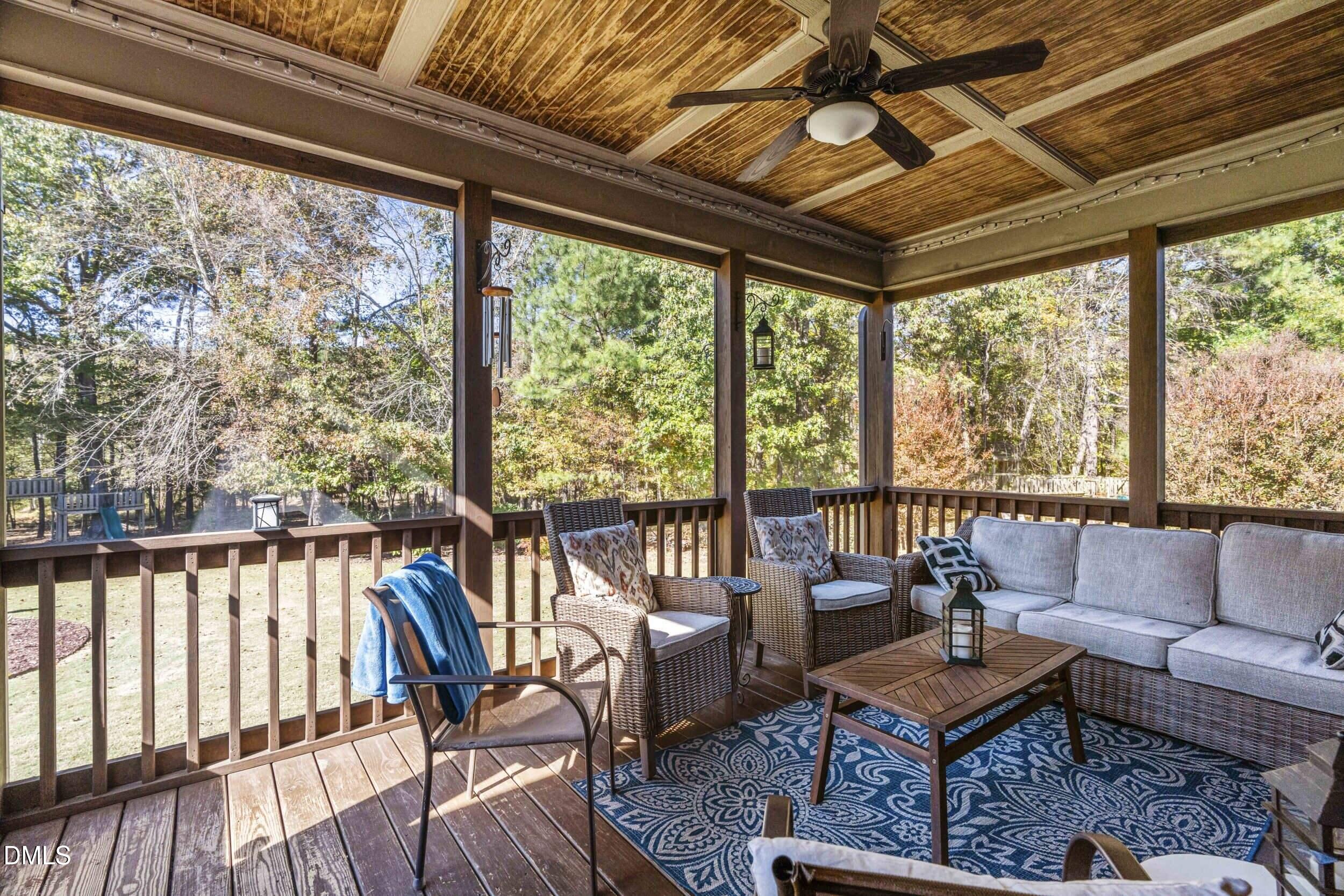 648 Fieldtrial Circle Garner, NC 27529 - Photo 41 of 56 a living room with furniture and a floor to ceiling window