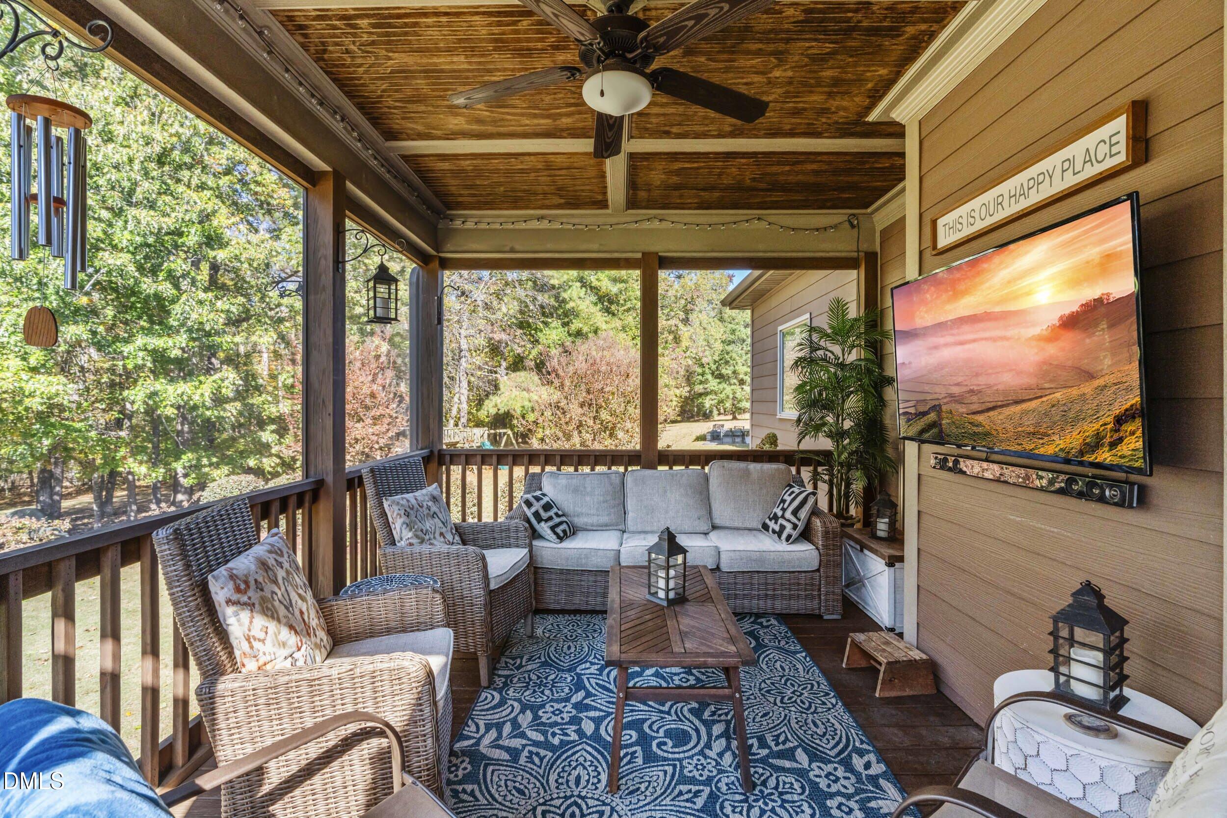648 Fieldtrial Circle Garner, NC 27529 - Photo 42 of 56 a living room with furniture tv and a large window