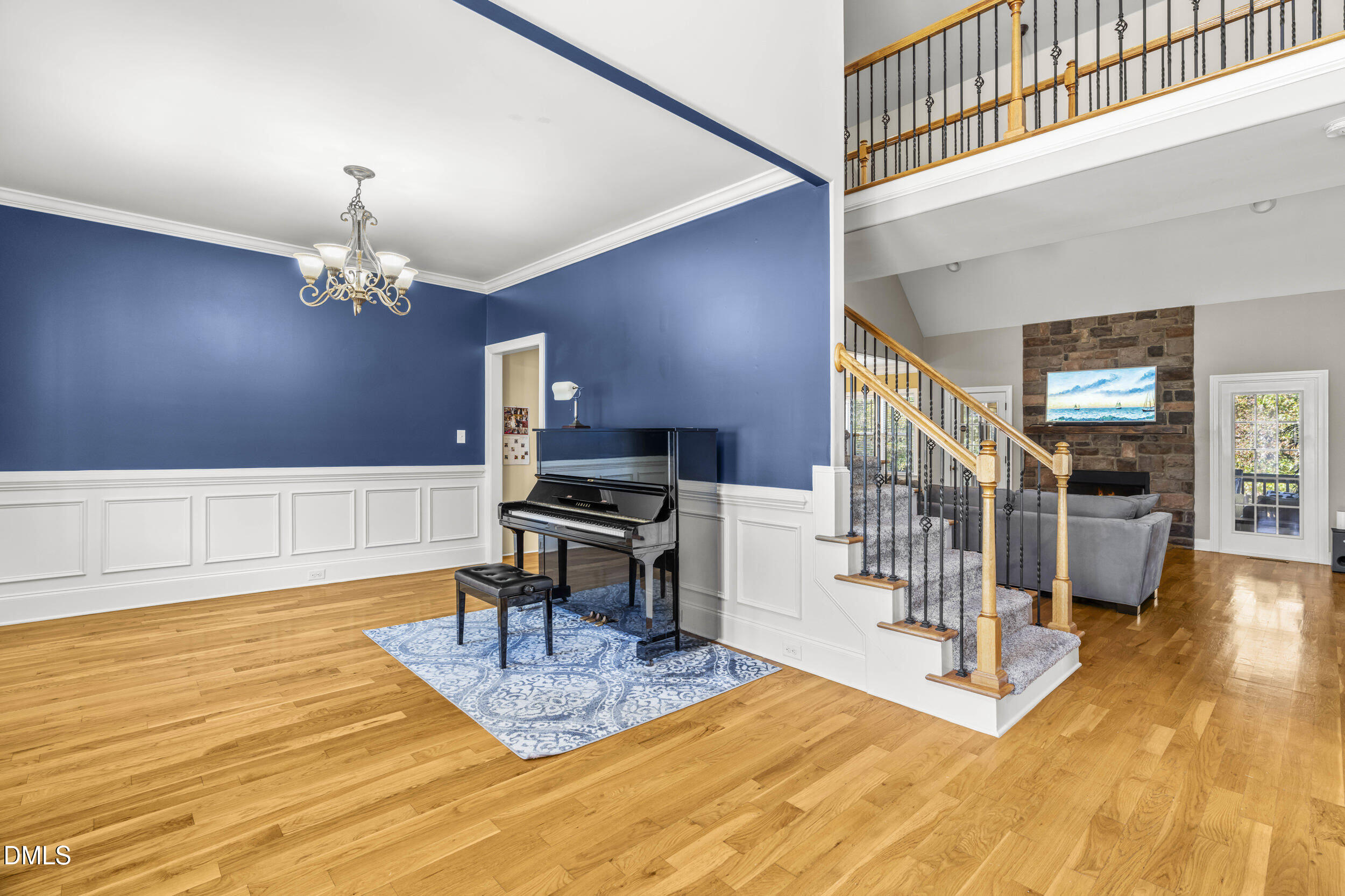 648 Fieldtrial Circle Garner, NC 27529 - Photo 8 of 56 a living room with stairs and a wooden floor