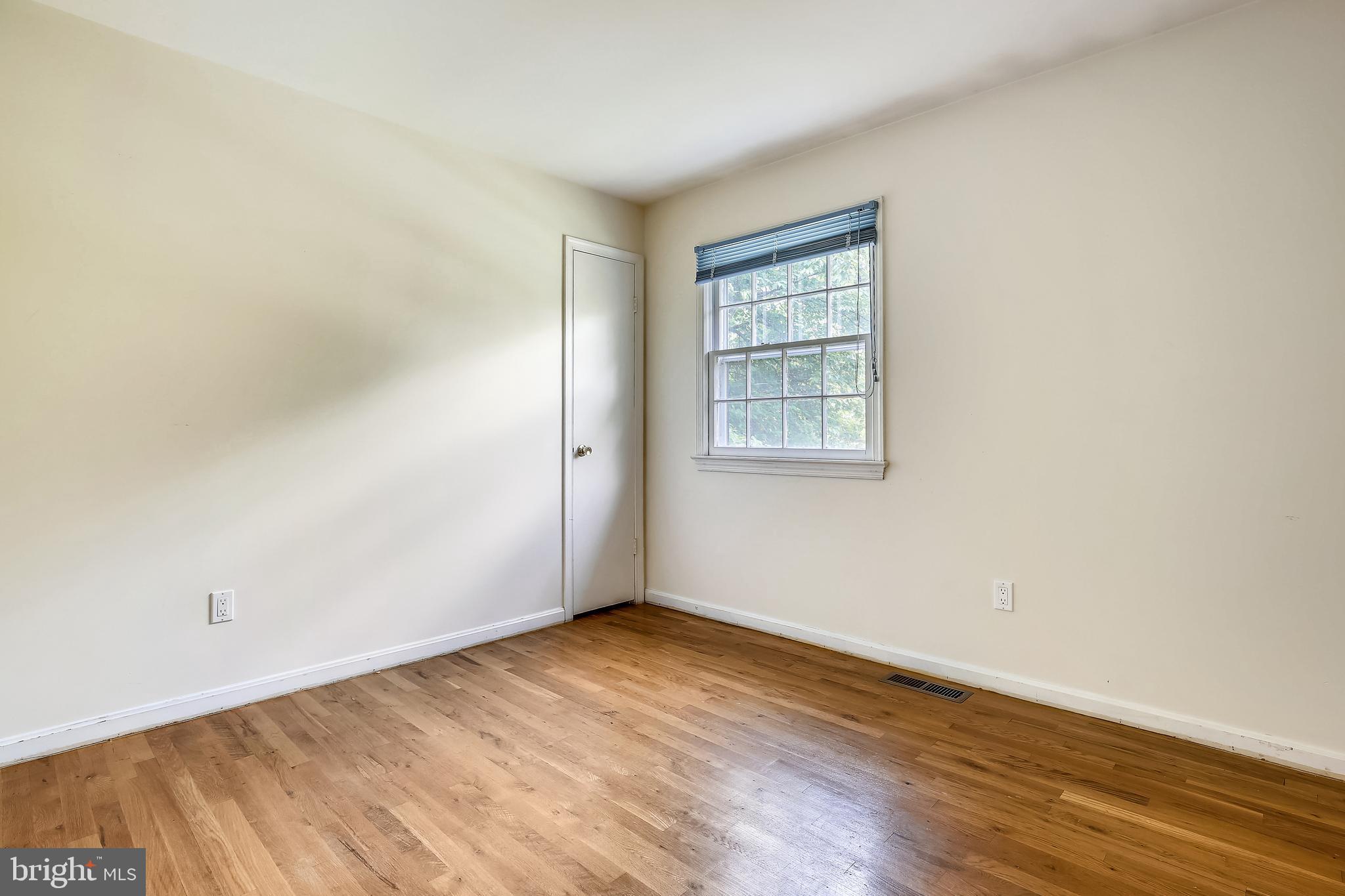9505 Emory Grove Road Gaithersburg, MD 20877 - Photo 19 of 75 an empty room with wooden floor and windows