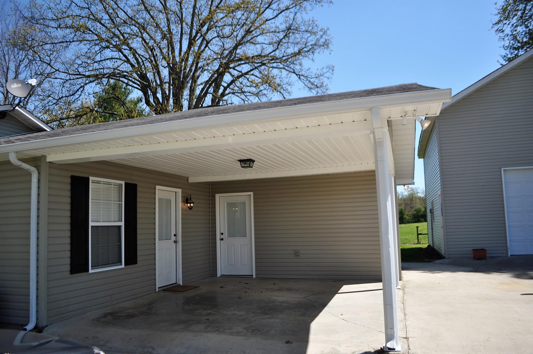 150 Crystal Springs Road Kelso, TN 37348 - Photo 2 of 21 a view of a blue house with a large tree