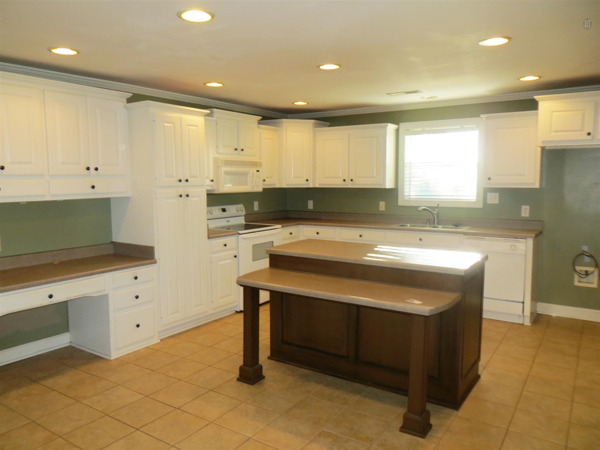 150 Crystal Springs Road Kelso, TN 37348 - Photo 17 of 21 a kitchen with a sink cabinets and window