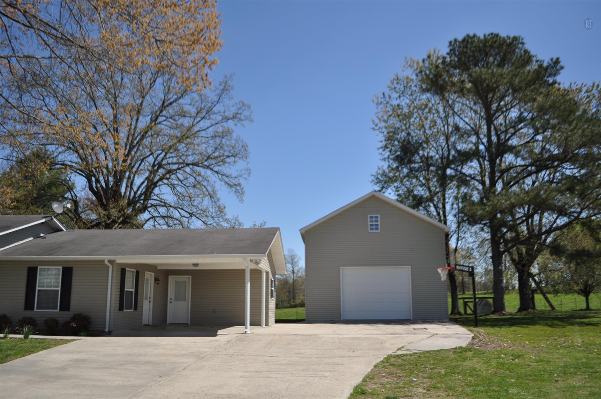 150 Crystal Springs Road Kelso, TN 37348 - Photo 3 of 21 a front view of a house with a yard and garage