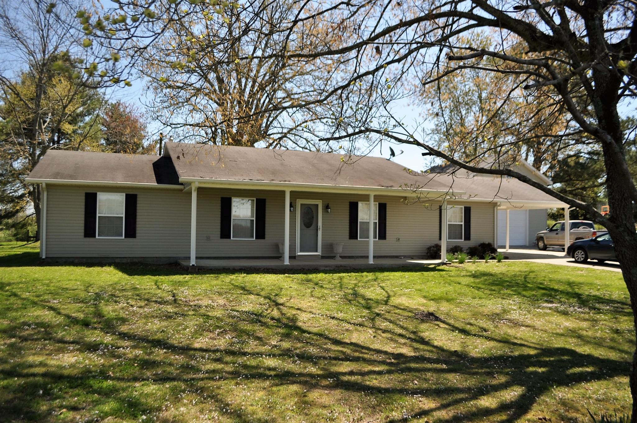150 Crystal Springs Road Kelso, TN 37348 - Photo 5 of 21 a front view of a house with a garden