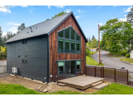 a view of house with backyard and outdoor seating